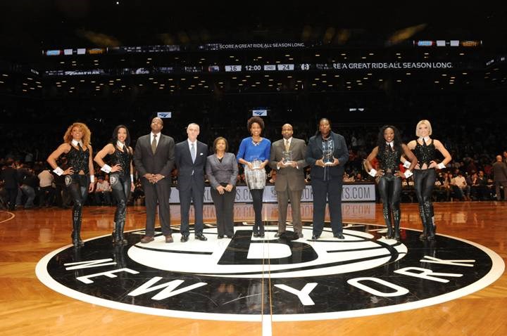 (L to R): Brooklynettes dancers with Ken Thompson, Brooklyn District Attorney; Brett Yormark, CEO of the Brooklyn Nets and Barclays Center; Darlene Abubakar, Senior Director of National Advertising and Marketing Programs for Amtrak; Janine Hausif, CEO and Founder of Around the Way mobile app; Mark Anthony Jenkins, Founder and Chairman of the New York African-American Chamber of Commerce; and Ruth Lovelace, Head Boys Basketball Coach at Boys & Girls High School in Brooklyn. Photo credit: Adam Pantozzi/ Brooklyn Nets