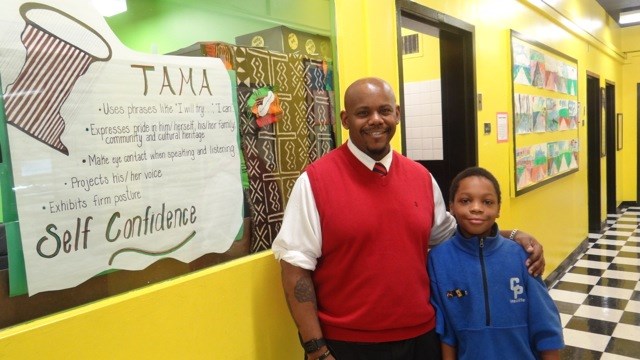 TFOA Professional Preparatory Charter School Founder and Co-Leader Rafiq Kalam Id-Din II with a student 