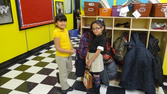 Two students at their cubbies before lunchtime at TFOA Professional Preparatory Charter School