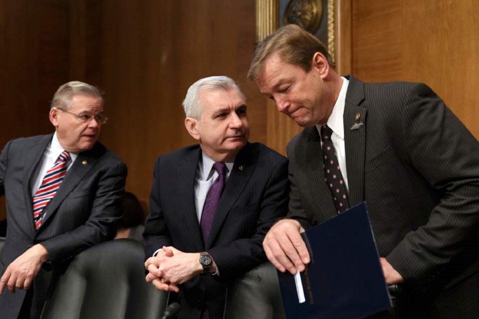 Associated Press file photo by J. Scott Applewhite -- Sen. Jack Reed, D-R.I., center, confers with Sen. Dean Heller, R-Nev., right, with Sen. Robert Menendez, D-N.J.,