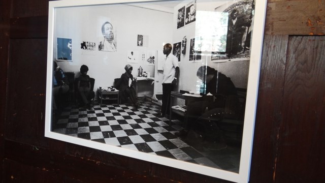 A framed photo of one of the original People's Free Medical Clinics hangs inside of the waiting room area. 
