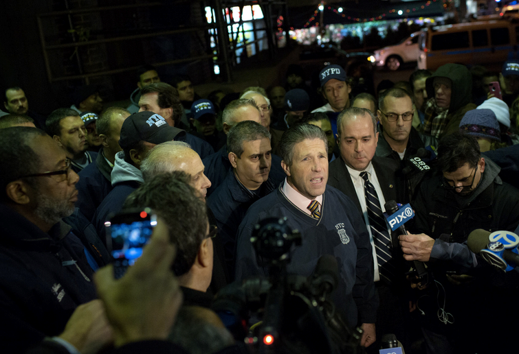 Patrick Lynch, president of the Patrolmen's Benevolent Association, addressing the media on Saturday outside the Woodhull Medical and Mental Health Center, where the two officers were taken after being sho