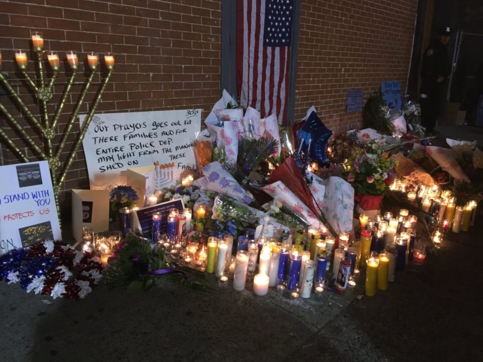 Shrine grows to honor slain NYPD officers