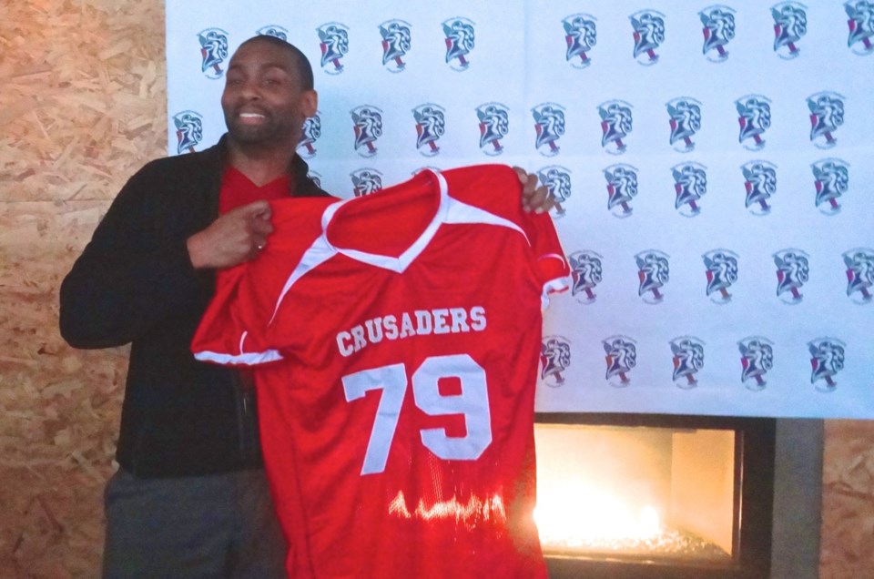 Bed-Stuy Crusaders Founder Tywan Anthony holds up an example of the new team jerseys at the media day at Vodou Bar on Sunday, April 19