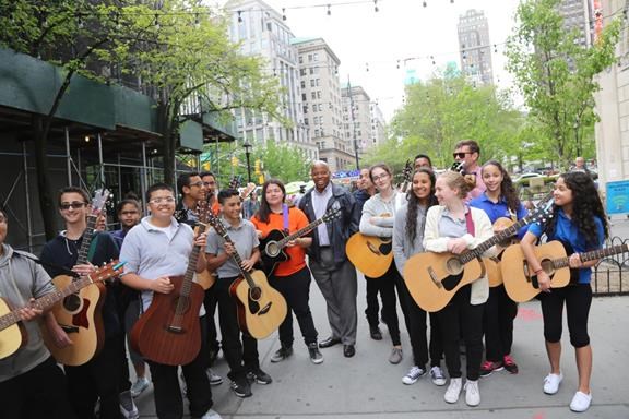 BP Eric Adams (center) with the guitar club at MS 577 Conselyea Preparatory School in Williamsburg before their performance in Willoughby Plaza.