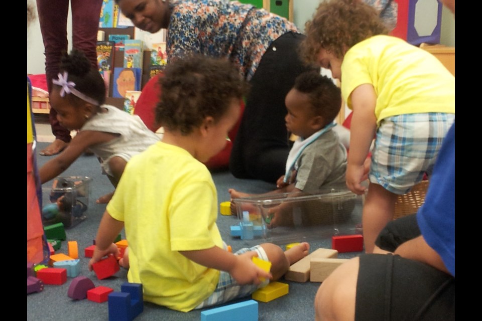 Children and parents playing together at &#8220;Baby &#038; Me&#8221; Playgroup. The task was to build a village!