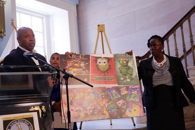 Brooklyn Borough President Eric L. Adams and Della Ellis, a resident of Downtown Brooklyn recovering from an addiction to K2, hold up a poster displaying examples of colorful packaging used to wrap the drug at a press conference in Brooklyn Borough Hall, where he issued a call to action to address synthetic marijuana's impact on public health and safety. Photo: Ron Ricardo/Brooklyn BP's Office