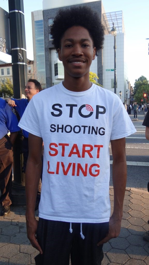 Robert David, 20: What moves me to be here today is the fact that I'm a young black American child. I want to encourage other black American children to not be in the street, go home early. Your life is better than picking up a gun. Hopefully the youth will see me and want to make a change. They'll feel that they have a brighter future. 
