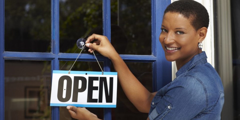 Woman standing in front of retail store.