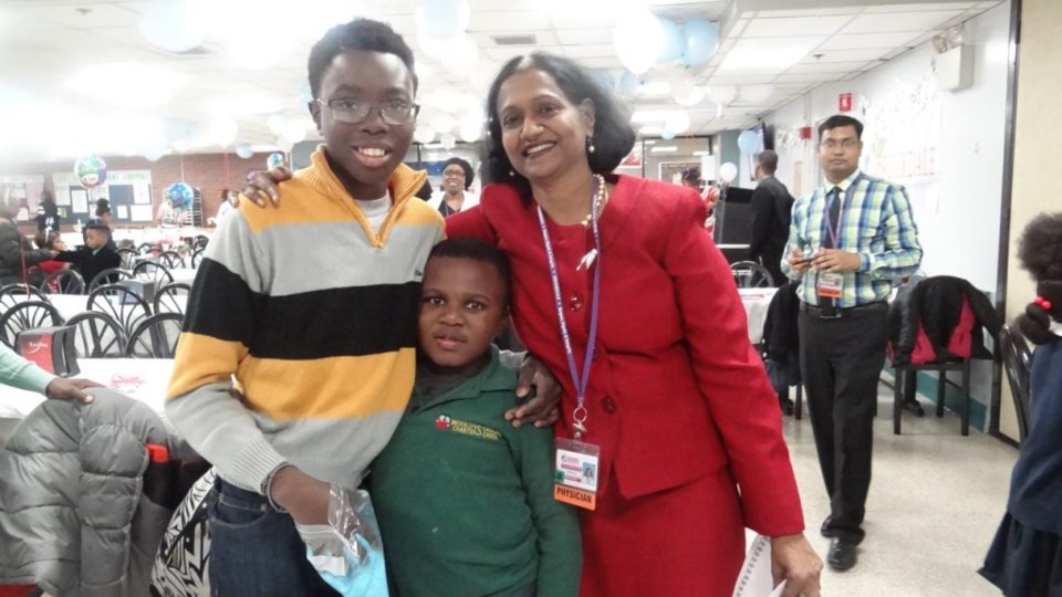 Dr. Kusum Viswanathan, Chair of the Department of Pediatrics and the Director of the Division of Pediatric Hematology/Oncology at Brookdale Hospital with a former patient and his sibling