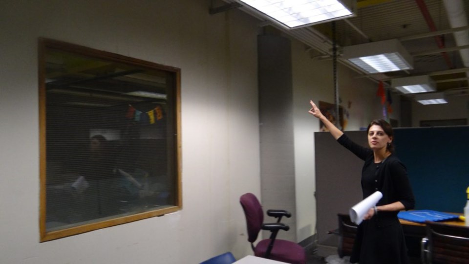 Brooklyn Children's Museum President Stephanie Wilchfort points to some water damage on one side of the afterschool room (Note: Children are kept away from this side of the room) 