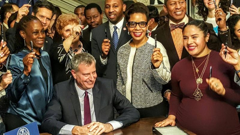 Mayor Bill de Blasio, First Lady Chirlane McCray, joined by Council Member Laurie A. Cumbo and other elected officials on stand with the mayor as he signed into law the Paid Paternal Leave Personnel Order for New York City workers