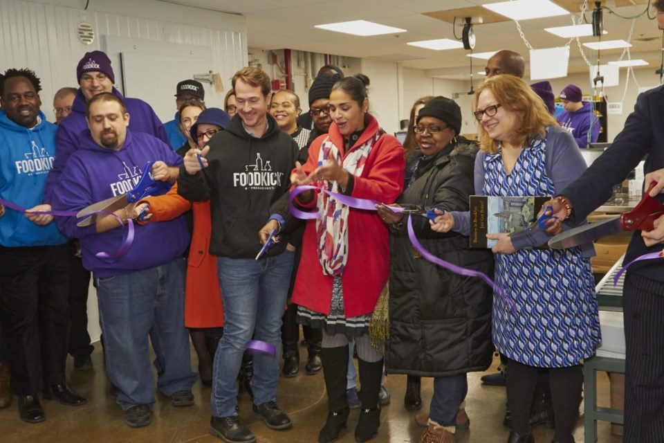 FreshDirect co-founder and CEO Jason Ackerman and  Deputy Brooklyn Borough President Diana Reyna (center) are joined by FoodKick staff as well as Brooklyn community partners for a ribbon cutting celebrating the launch of the new on-demand food business