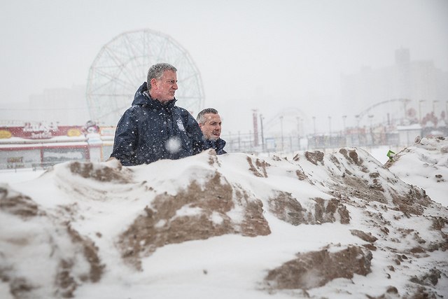 New York City Mayor Bill de Blasio stands with the Director of The Mayor's Office of Recovery and Resiliency, Daniel Zarrilli on a temporary sand berm which was built to protect against storm surge flooding on the beach at Coney Island during a major snowstorm on Saturday, January 23, 2016. Michael Appleton/Mayoral Photography Office