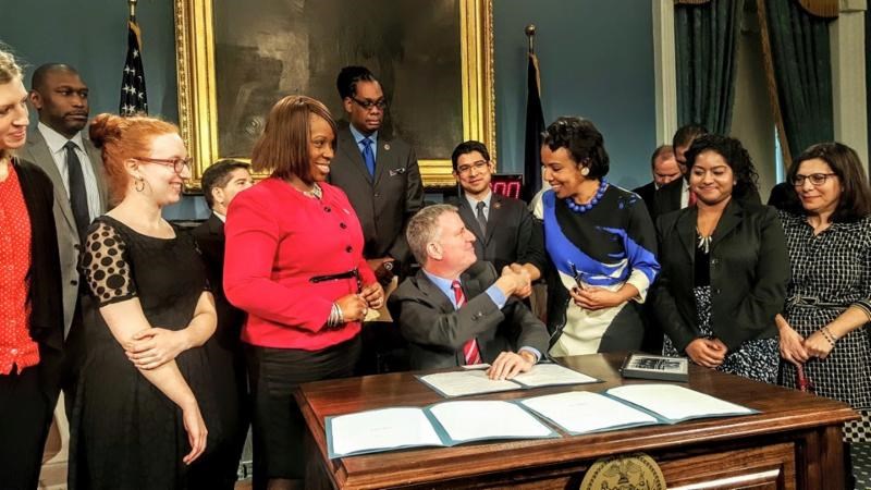 Mayor Bill de Blasio congratulates Council Member Laurie A. Cumbo after signing her bill, Intro 952 into law on Monday in the Blue Room of City Hall.