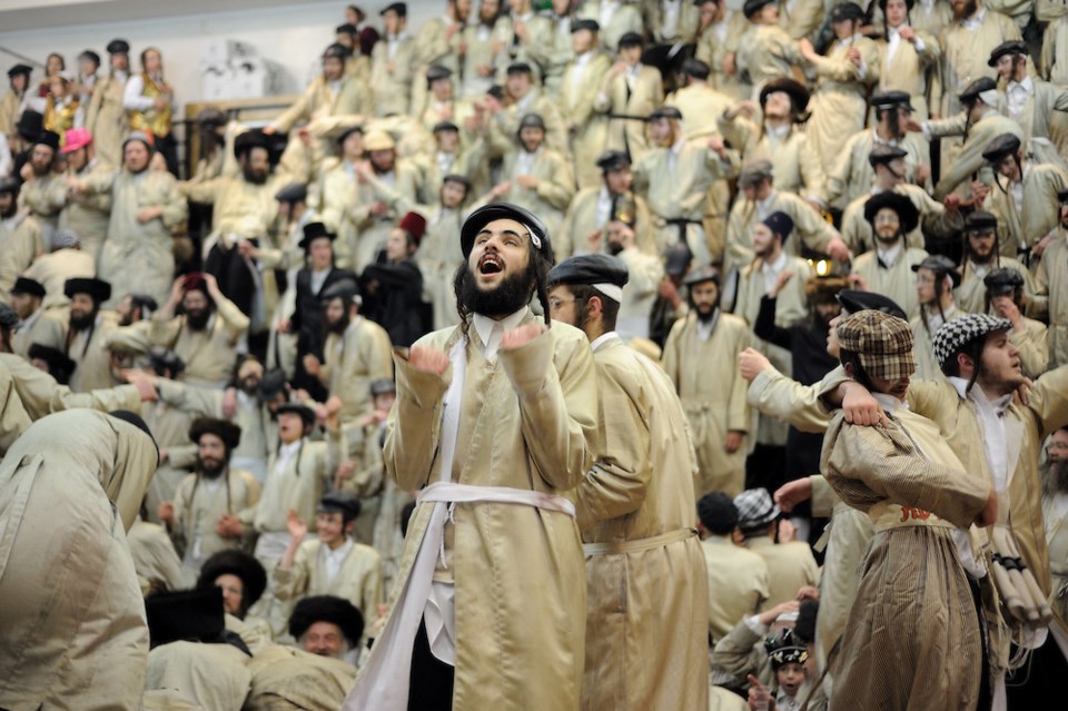 JERUSALEM, ISRAEL - MARCH 17, 2014: Ultra-Orthodox Jewish men of the Toldot Aharon Sect celebrate the Purim holiday in the ultra-orthodox Mea Shearim neighborhood in Jerusalem on March 17, 2014. The festival of Purim commemorates the rescue of Jews from a genocide in ancient Persia. Photo by Gili Yaari