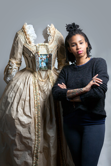 Artist Fabiola Jean Louis stands next to the paper sculpture used in the portrait, "Madame Leroy" Photo: www.broadwayworld.com