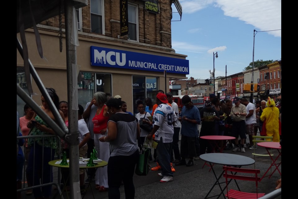 People wait in line for food