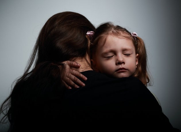 Sad crying daughter hugging her mother