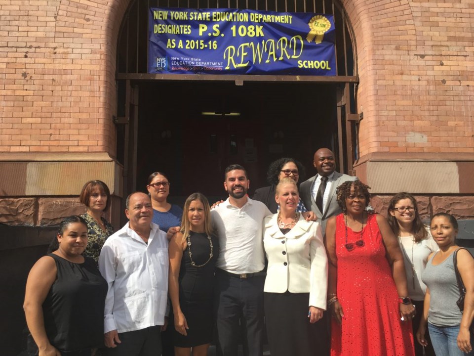 City Councilmember Rafael Espinal (center) stands with NYC Schools Chancellor Carmen Farina, State Sen. Martin Malavé Dilan and school administrators at press conference announcing $17.45 million Espinal secured for schools in his district.