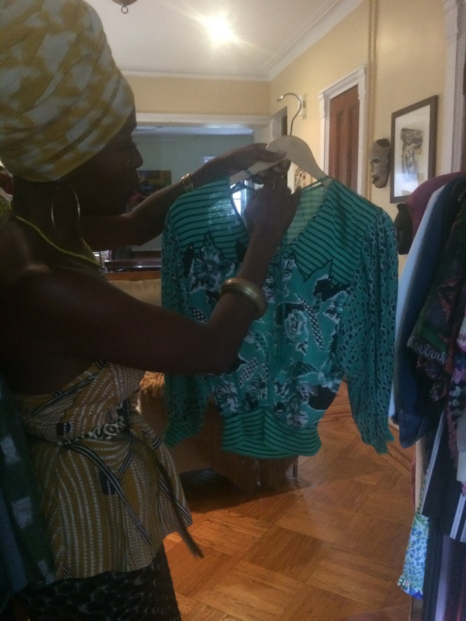 Roberts adjusting a patterned teal blouse