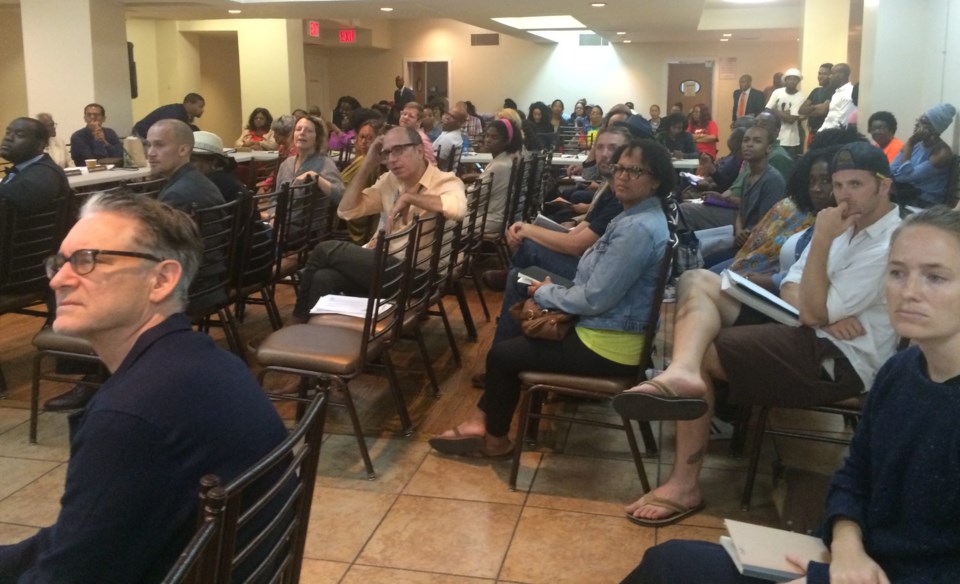 At the Community Board 3 meeting, the crowd listens to a public hearing presentation.