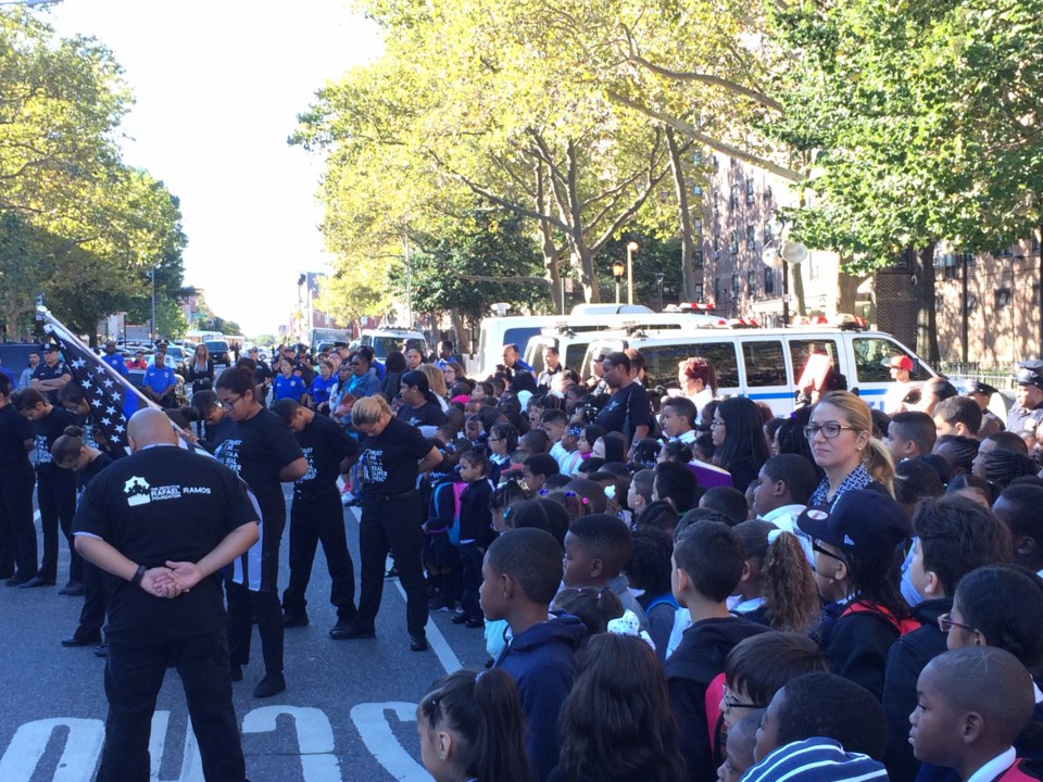 Students from P.S. 59 watch the Ramos Foundation's student drill team perform.