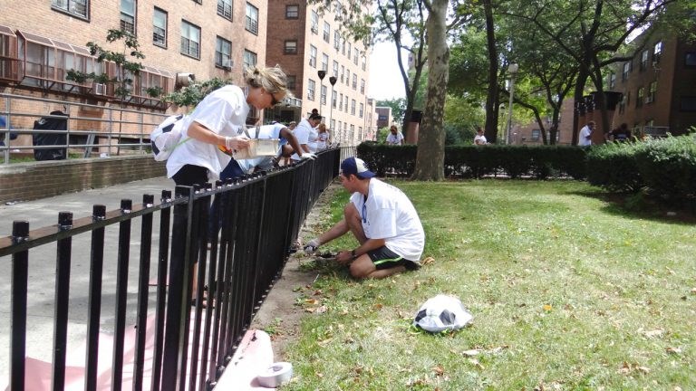 Afropunk Army Volunteers repaint fences at Van Dyke Houses in Brownsville