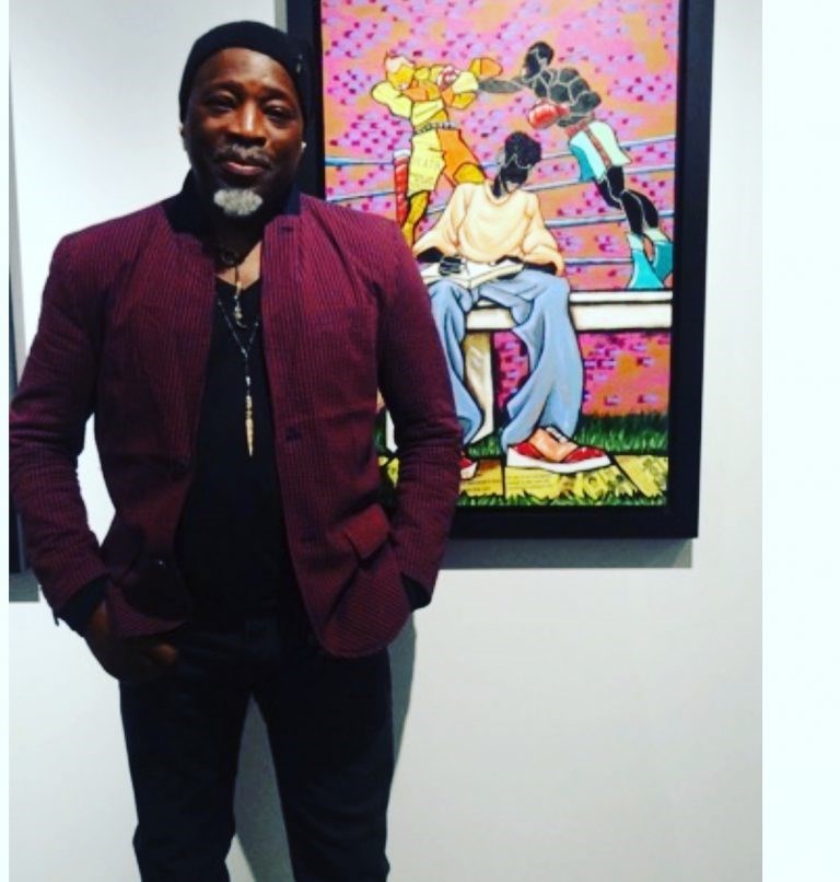 Leroy Campbell stands in front of one of his portraits for the exhibit "The Fight Continues" at the Richard Beavers Gallery.