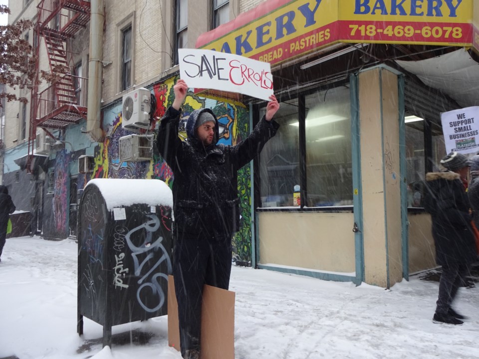 Man hold sign reading &#8216;Save Errol&#8217;s&#8217;