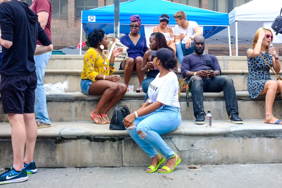 Happy festivalgoers at Tap+Cork 2017, lounging at Restoration Plaza