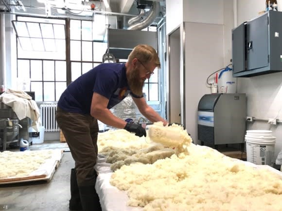 Doughan mixes the steamed rice before it is mixed into the fermentation tanks