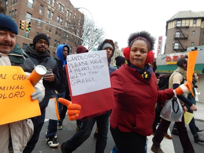 Flatbush-Tenant-Coalition-housing-justice-march-marcher-with-sign-702&#215;526