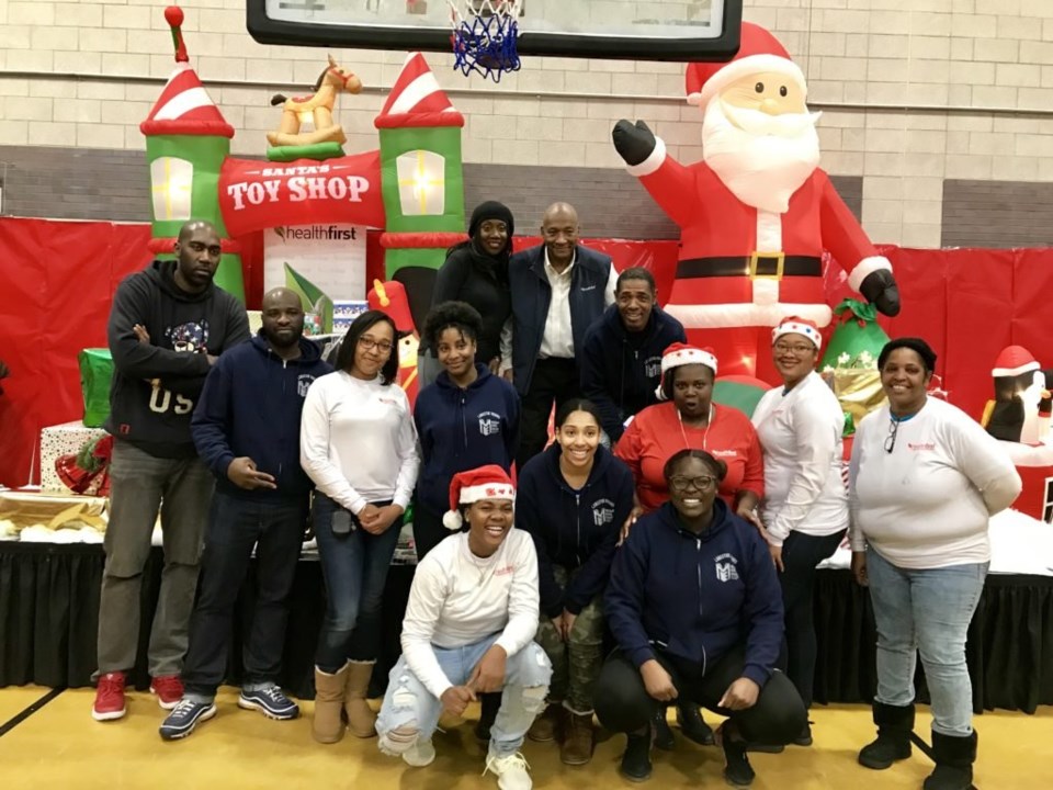 More than 60 HealthFirst employees and Brownsville residents came together to make the annual Toyland a truly cheerful experience for the Brownsville community. Photo credit: