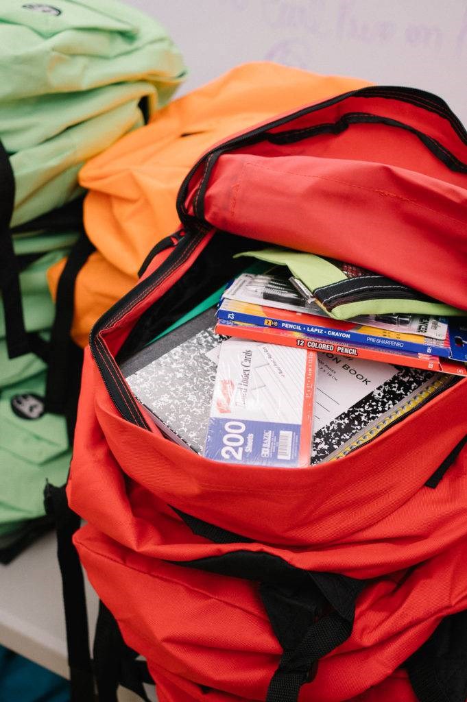 During the community gathering, the organization gave out 100 free backpacks filled with school supplies to local elementary and high school students.