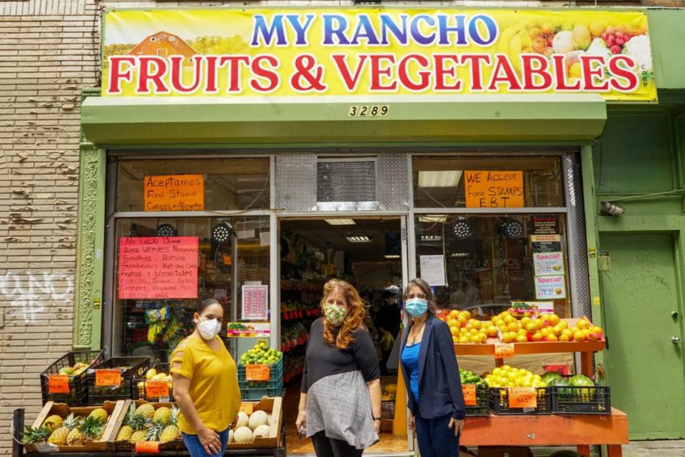 CHCCC team Maria Rodriguez, Maria Collier and Mildred Badillo outside a store opened by parents of a former student. Photo by Russell Frederick.