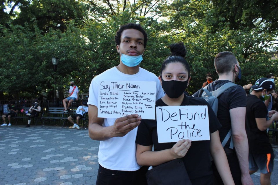 Hanief Dykes and Mellany Heras were handing out free water at the vigil. Photo: Anna Bradley-Smith for BK Reader.