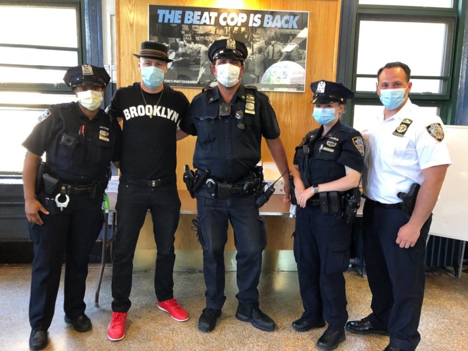 Sergio Delavicci posing with Brooklyn NYPD