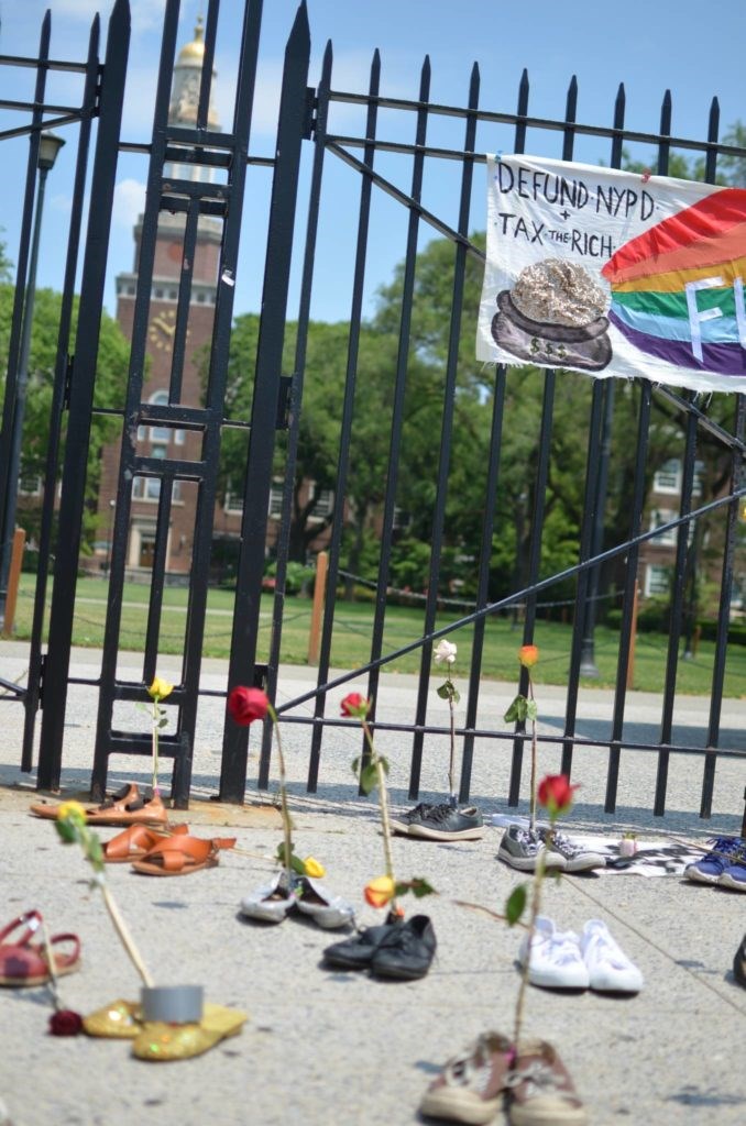 Shoes filled with flowers in front of Brooklyn College representing 52 adjuncts who were laid off without healthcare