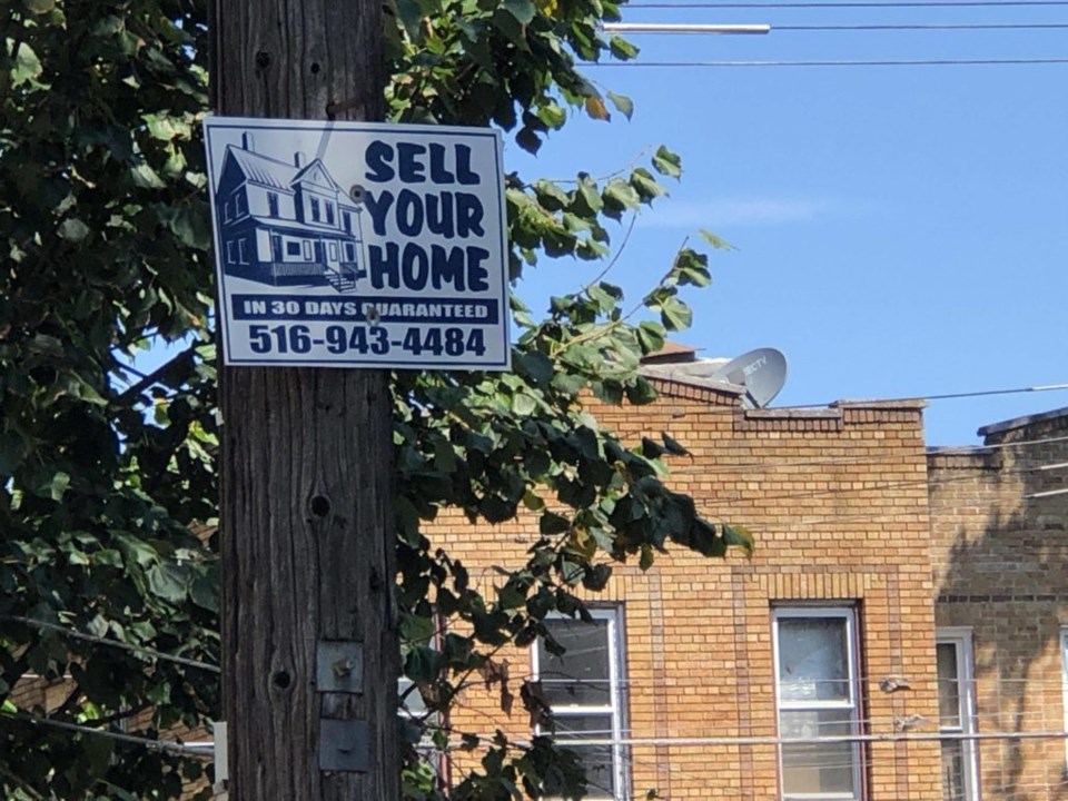 Sell your house sign in East New York