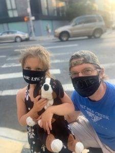 Frank Boudreaux and his daughter Fiona Boudreaux wearing masks on a walk in their neighborhood.