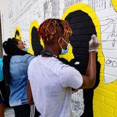 Young Brownsville residents painting a BLM inspired mural. Photo: Youth Design Center.