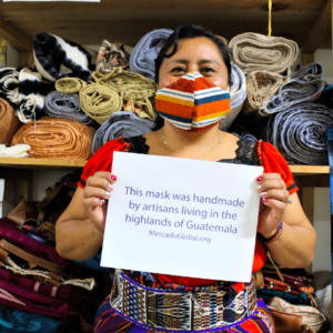 An artisan at work, modeling her mask. Photo: provided. 