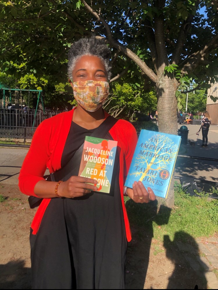 A reader at the Free Black Women's Library pop-up browsing Black women writers. Photo: OlaRonke Akinmowo.