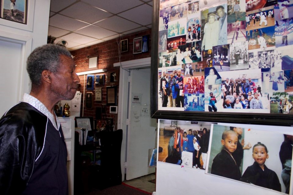 Chief Master Sabu Lewis's teachings have touched many lives in Brooklyn. Here he is, looking at a wall of mementos. Photo: Miranda Levingston for the BK Reader.