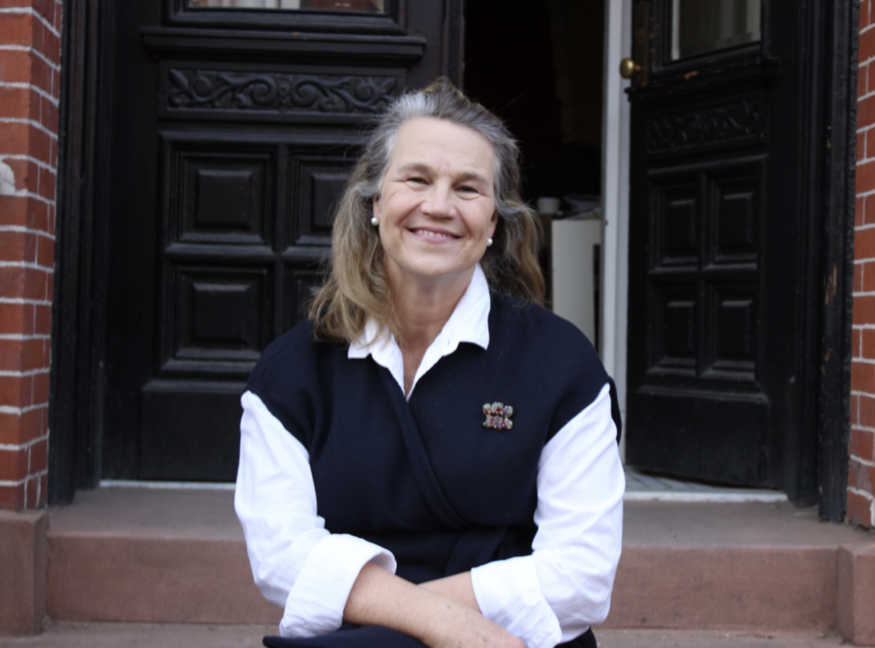 Cecilia Clarke on her front stoop in Fort Greene, wearing a brooch that belonged to her mother. Photo: Miranda Levingston for the BK Reader.