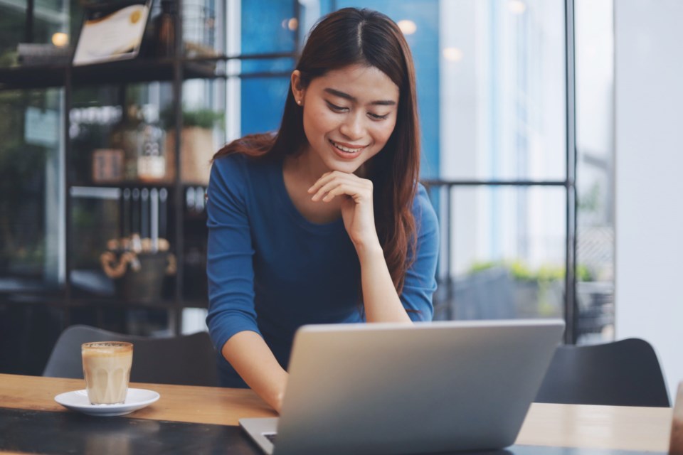 Attractive,Young,Asian,Woman,Working,With,Laptop,In,Co-working,Space.