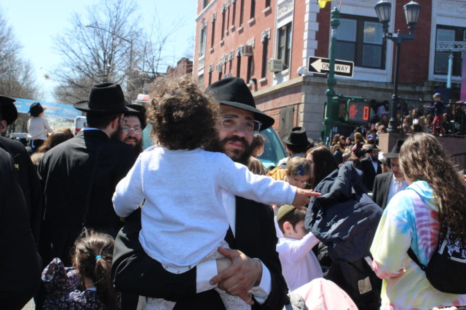 A parade goer and his youngling. Photo: Miranda Levingston for the BK Reader. 