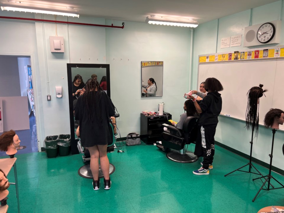 Young ladies getting their eyebrows and hair done at Bushwick Leaders HIgh School on April 12, 2022.