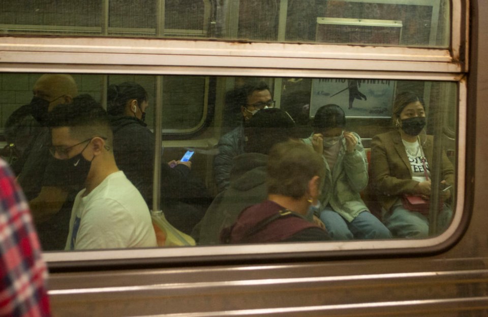 Commuters on an N train